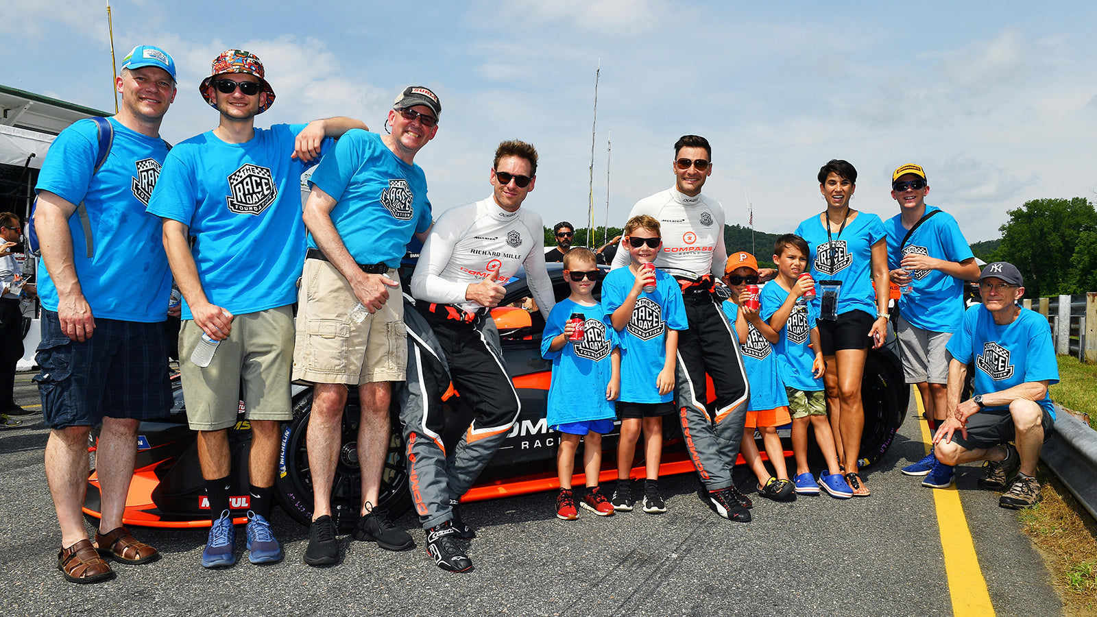 Race Day Foundation employees with children on a racetrack