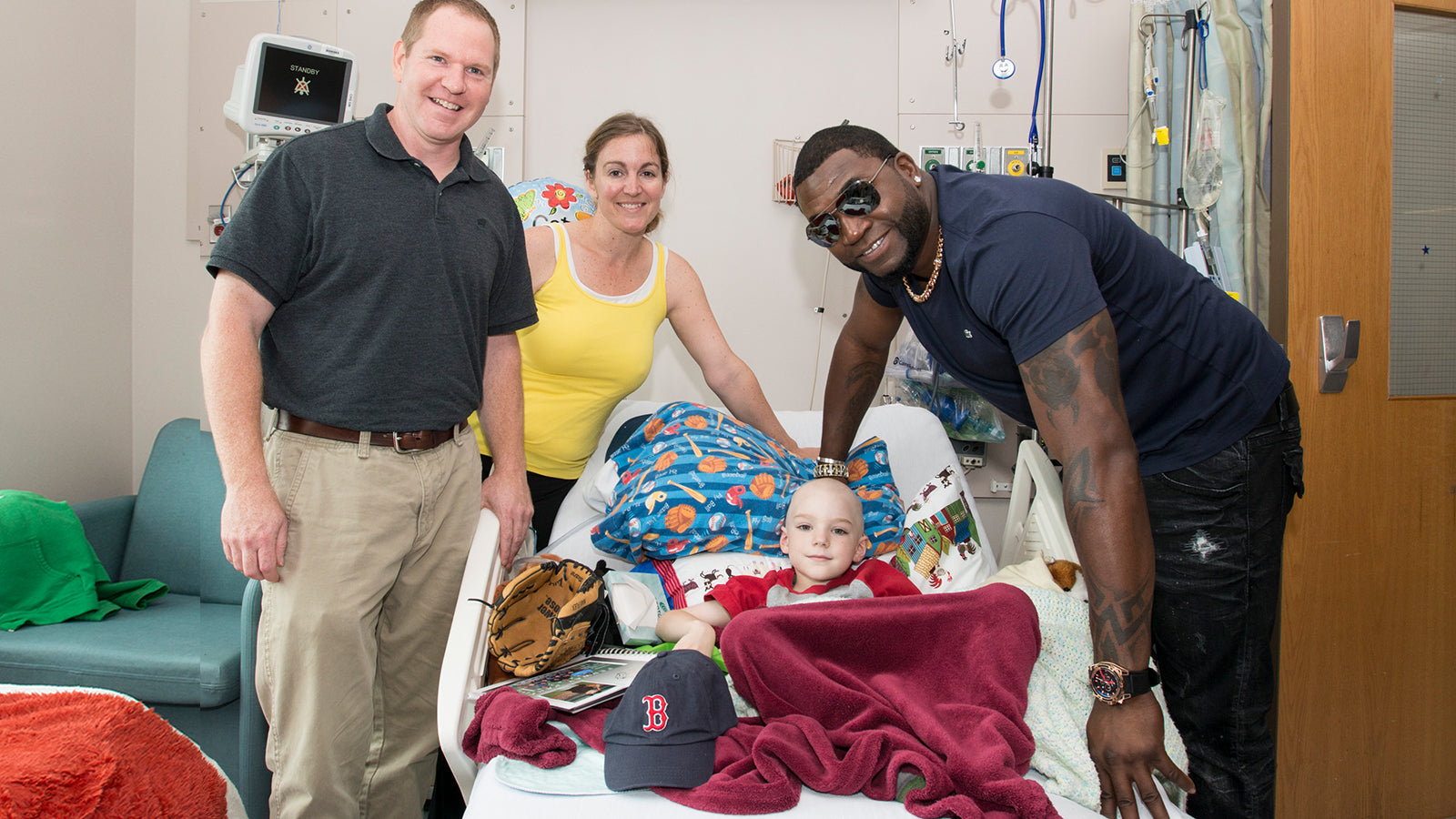 David Ortiz visiting a child in a hospital